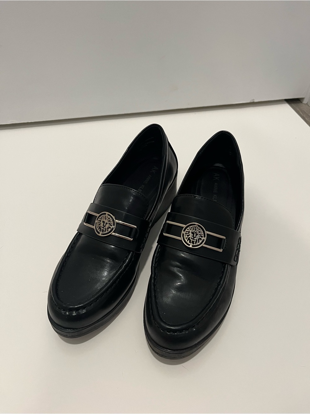 Anne Klein Black Wedge Loafers with Gold-Tone Medallion
